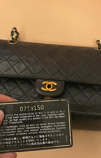 Iconic black CHANEL Timeless bag with authenticity card